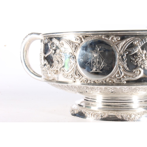 62 - Victorian silver twin handled punch bowl with gilded interior and embossed ornate designs of garland... 