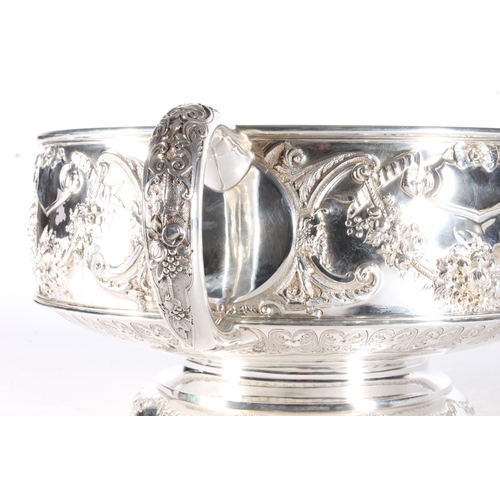 62 - Victorian silver twin handled punch bowl with gilded interior and embossed ornate designs of garland... 