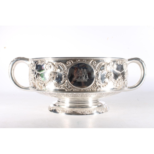 62 - Victorian silver twin handled punch bowl with gilded interior and embossed ornate designs of garland... 