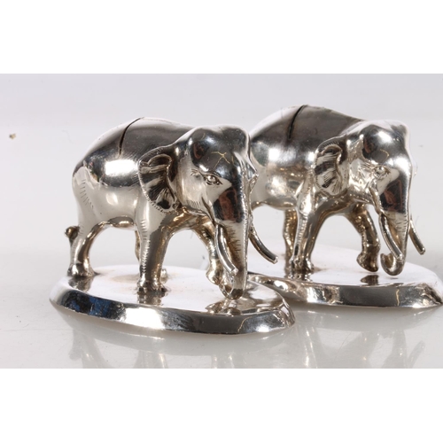 122 - Set of four novelty white metal menu or place holders in the form of elephants.