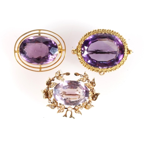 183 - Three gold mounted amethyst brooches, 19.4g gross.