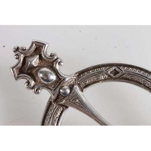 155 - Unmarked white metal Scottish penannular brooch of large proportions and typical form, 58g gross.