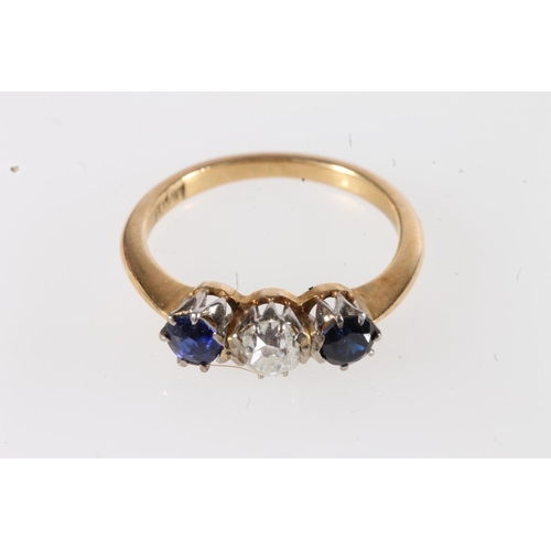 180 - 18ct gold diamond and sapphire three stone ring, the central 0.12ct diamond flanked by deep blue sap... 