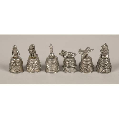 37 - Assortment of animal design white metal thimbles, military compass in leather pouch, and silver hand... 