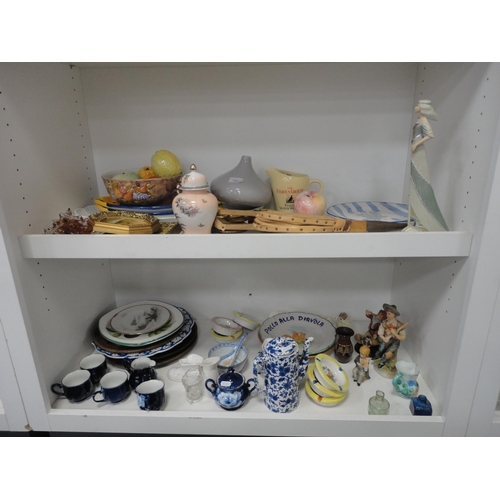 100 - Two shelves of sundry ceramics to include whisky jug, figures, dishes and bellows etc.