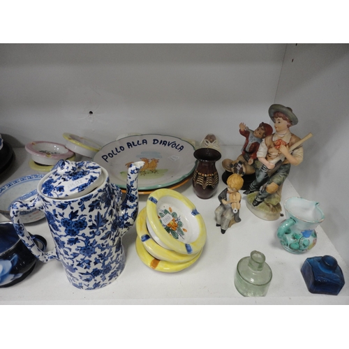 100 - Two shelves of sundry ceramics to include whisky jug, figures, dishes and bellows etc.