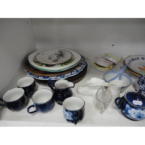 100 - Two shelves of sundry ceramics to include whisky jug, figures, dishes and bellows etc.