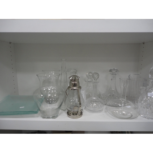 105 - Shelf lot of glass to include crystal decanters with stoppers, glass jugs and vases.