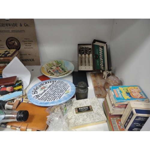 106 - Shelf lot of sundries to include ship in a bottle, telephone, playing cards, books, bookends etc