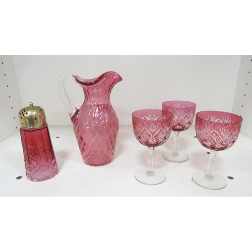 110B - Cranberry glass jug and sugar sifter, with three tinted crystal cranberry glasses. (5)