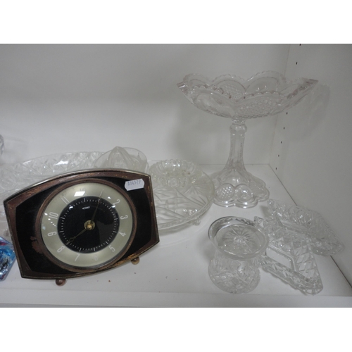 112 - Two shelves of assorted glass to include bowls, basket etc with Metamec mantel clock.