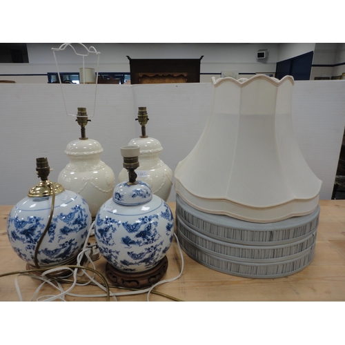 129 - Pair of Creamware ceramic table lamps with two of Chinese style blue and white ceramic table lamps, ... 