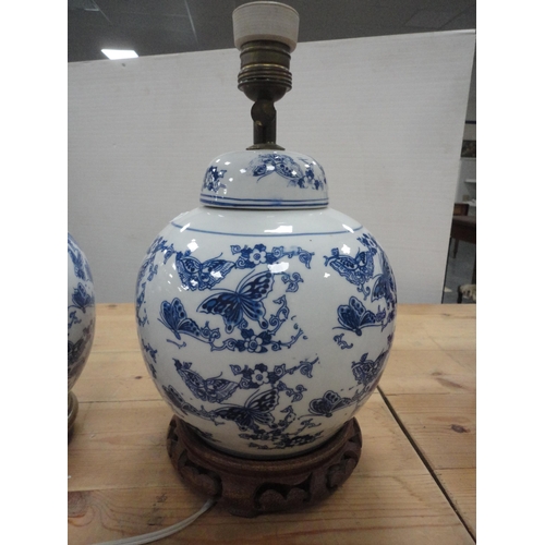 129 - Pair of Creamware ceramic table lamps with two of Chinese style blue and white ceramic table lamps, ... 