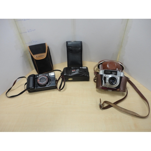 139 - Mantel clock with cased Canon camera and two others. (4)