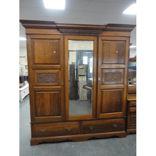 213 - Late Victorian carved two-piece bedroom suite comprising mirror-door wardrobe and kneehole dressing ... 