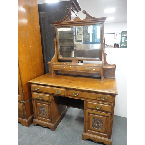 213 - Late Victorian carved two-piece bedroom suite comprising mirror-door wardrobe and kneehole dressing ... 