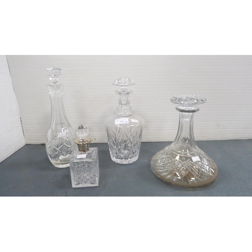 53 - Group of cut glass and crystal to include three decanters and stoppers, small toilet bottle with whi... 