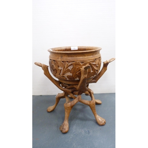 55 - Indian-style carved wooden bowl on folding stand.