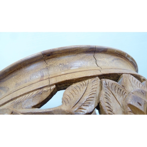 55 - Indian-style carved wooden bowl on folding stand.