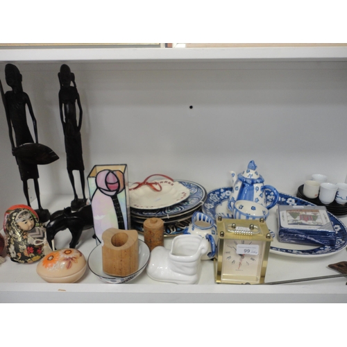 99 - Shelf lot to include sundry ceramics, carriage clock and tribal figures etc