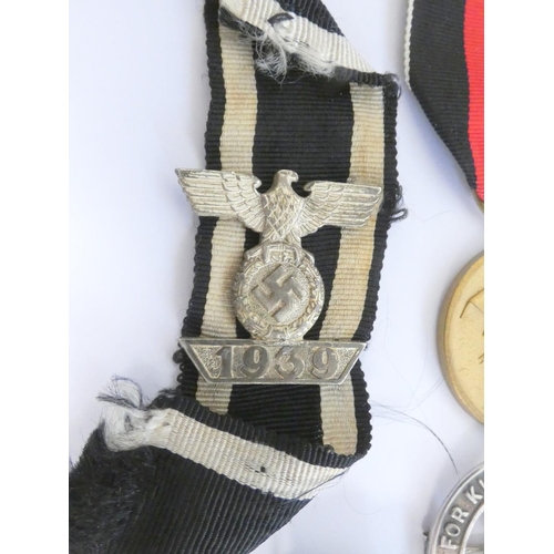 304 - Military Awards. Awards group to include a 1939 clasp for the Iron Cross 2nd class, a NSDAP party fl... 