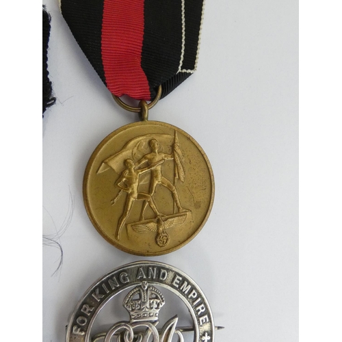 304 - Military Awards. Awards group to include a 1939 clasp for the Iron Cross 2nd class, a NSDAP party fl... 