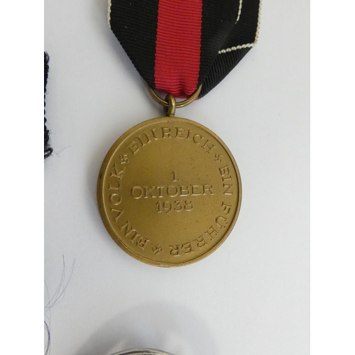 304 - Military Awards. Awards group to include a 1939 clasp for the Iron Cross 2nd class, a NSDAP party fl... 