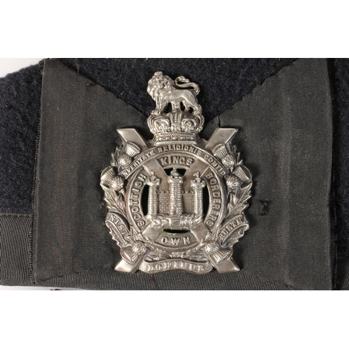 1759 - Unhallmarked white metal Kings Own Scottish Borderers white metal cap badge on a black cloth glengar... 