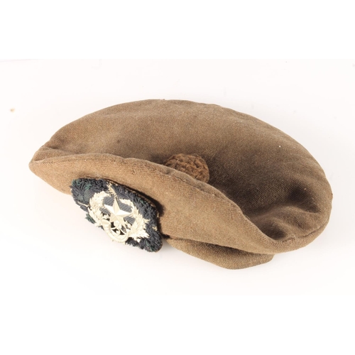 1762 - Unhallmarked die stamped white metal Cameronians cap badge on a khaki green bonnet.