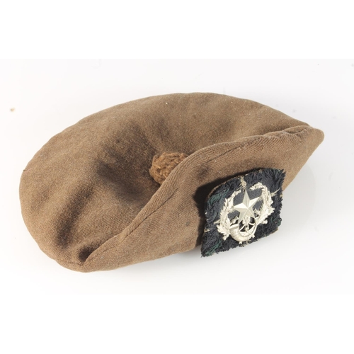 1762 - Unhallmarked die stamped white metal Cameronians cap badge on a khaki green bonnet.