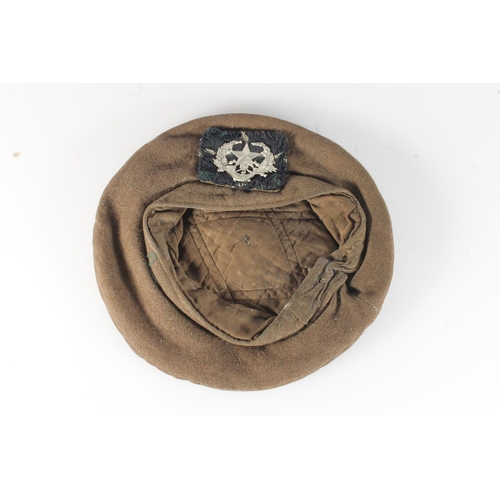 1762 - Unhallmarked die stamped white metal Cameronians cap badge on a khaki green bonnet.