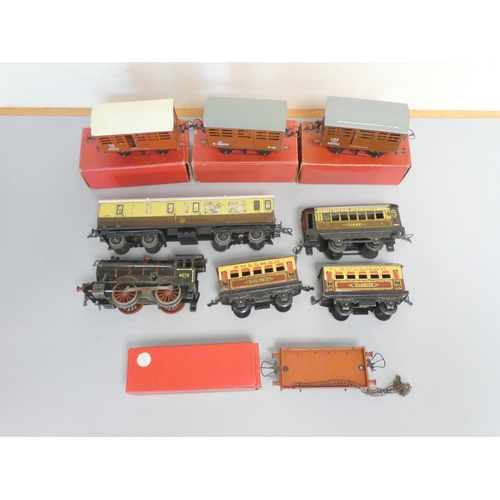 215 - Hornby. Tinplate models to include three boxed 0 gauge No.1 Cattle Trucks, a No.2 LNER black tank lo... 