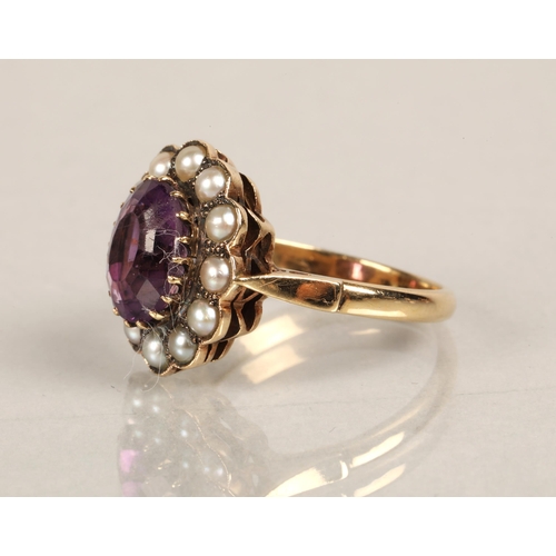 55 - 9ct gold ring set with a purple gem surrounded by seed pearls, ring size O, 4.4g