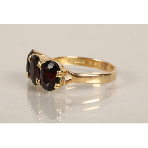 73 - 9ct gold ring set with three garnets, ring size Q, 3.8g