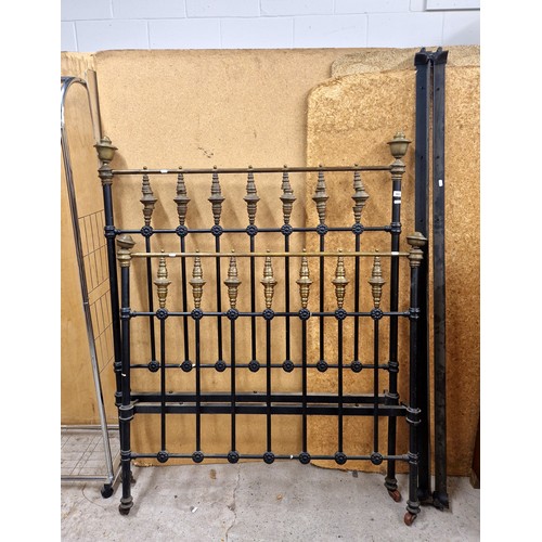 588 - Antique wrought iron and brass bed frame on casters