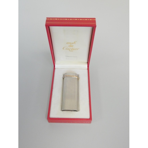 351 - Must de Cartier brushed steel and gold banded trilogy lighter serial number 96141V. Complete with bo... 