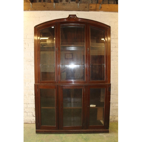 556 - Early 20th century cabinet bookcase, the shaped arch top above six glazed panel cupboard doors, rais... 