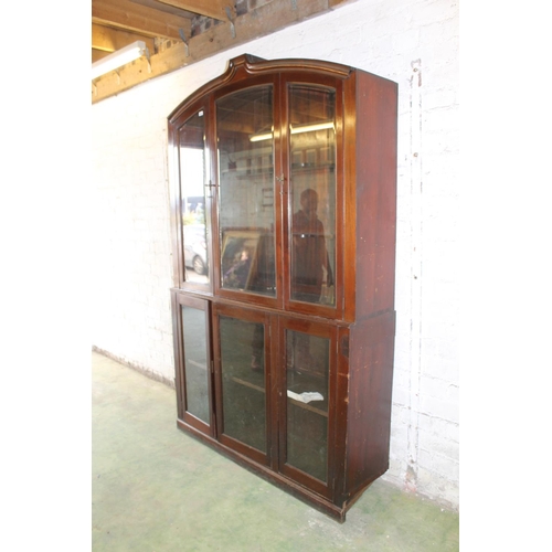 556 - Early 20th century cabinet bookcase, the shaped arch top above six glazed panel cupboard doors, rais... 