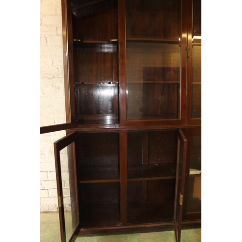 556 - Early 20th century cabinet bookcase, the shaped arch top above six glazed panel cupboard doors, rais... 