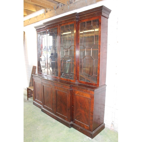 557 - Antique figured mahogany four door breakfront library bookcase, the cornice with dentil work frieze ... 