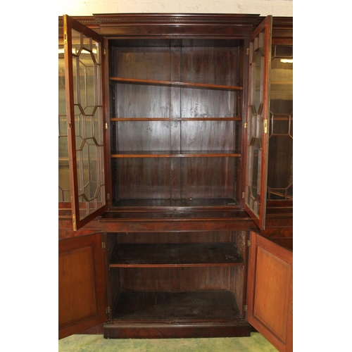 557 - Antique figured mahogany four door breakfront library bookcase, the cornice with dentil work frieze ... 