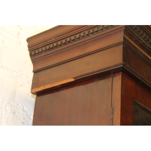 557 - Antique figured mahogany four door breakfront library bookcase, the cornice with dentil work frieze ... 