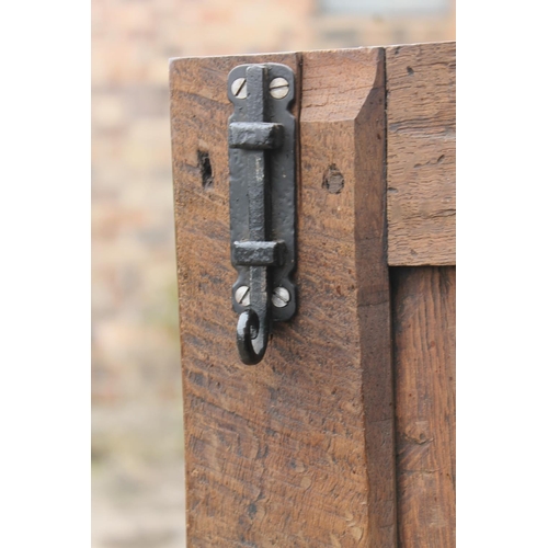 561 - Antique oak two door cupboard or wardrobe, raised on bun feet, 124cm wide.