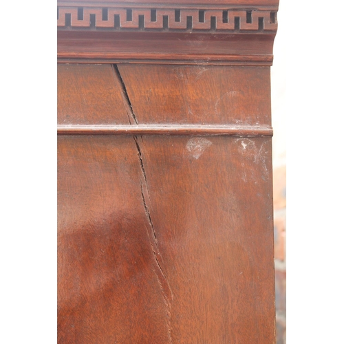 565 - 20th century mahogany serpentine fronted wardrobe, the cornice with Greek key frieze, raised on spla... 