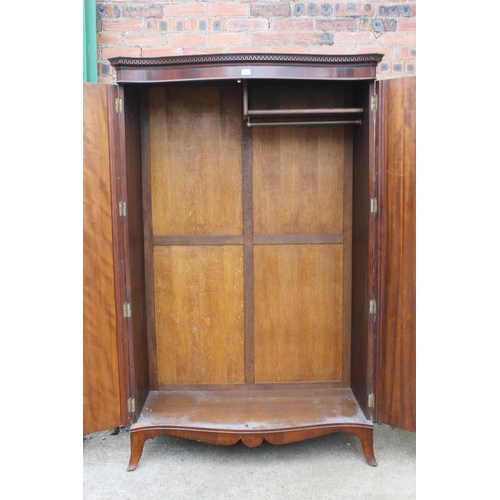 565 - 20th century mahogany serpentine fronted wardrobe, the cornice with Greek key frieze, raised on spla... 