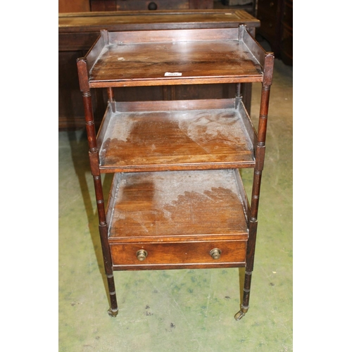 566 - Antique rosewood étagère with base drawer raised on turned supports capped by castors, 43cm wide.