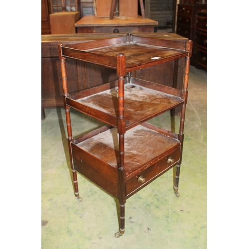 566 - Antique rosewood étagère with base drawer raised on turned supports capped by castors, 43cm wide.