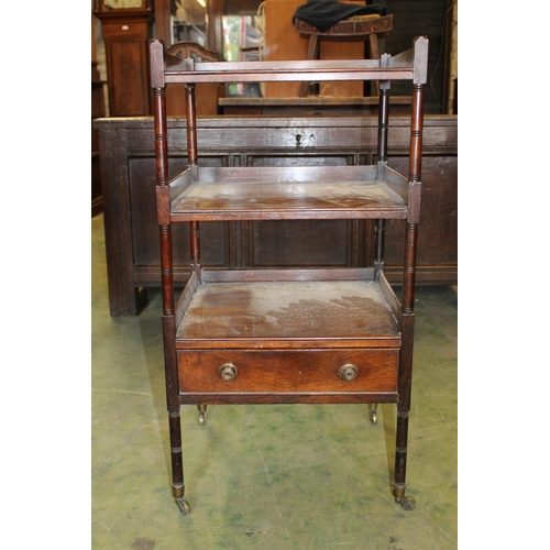 566 - Antique rosewood étagère with base drawer raised on turned supports capped by castors, 43cm wide.