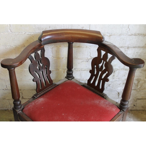 567 - Antique mahogany corner chair having yoke shaped arm rests, pierced splats, raised on a cabriole leg... 