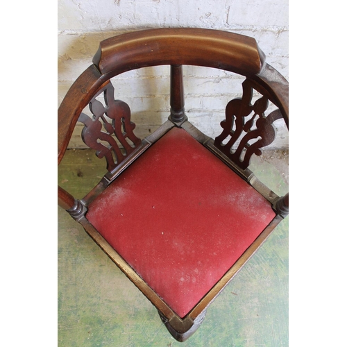 567 - Antique mahogany corner chair having yoke shaped arm rests, pierced splats, raised on a cabriole leg... 